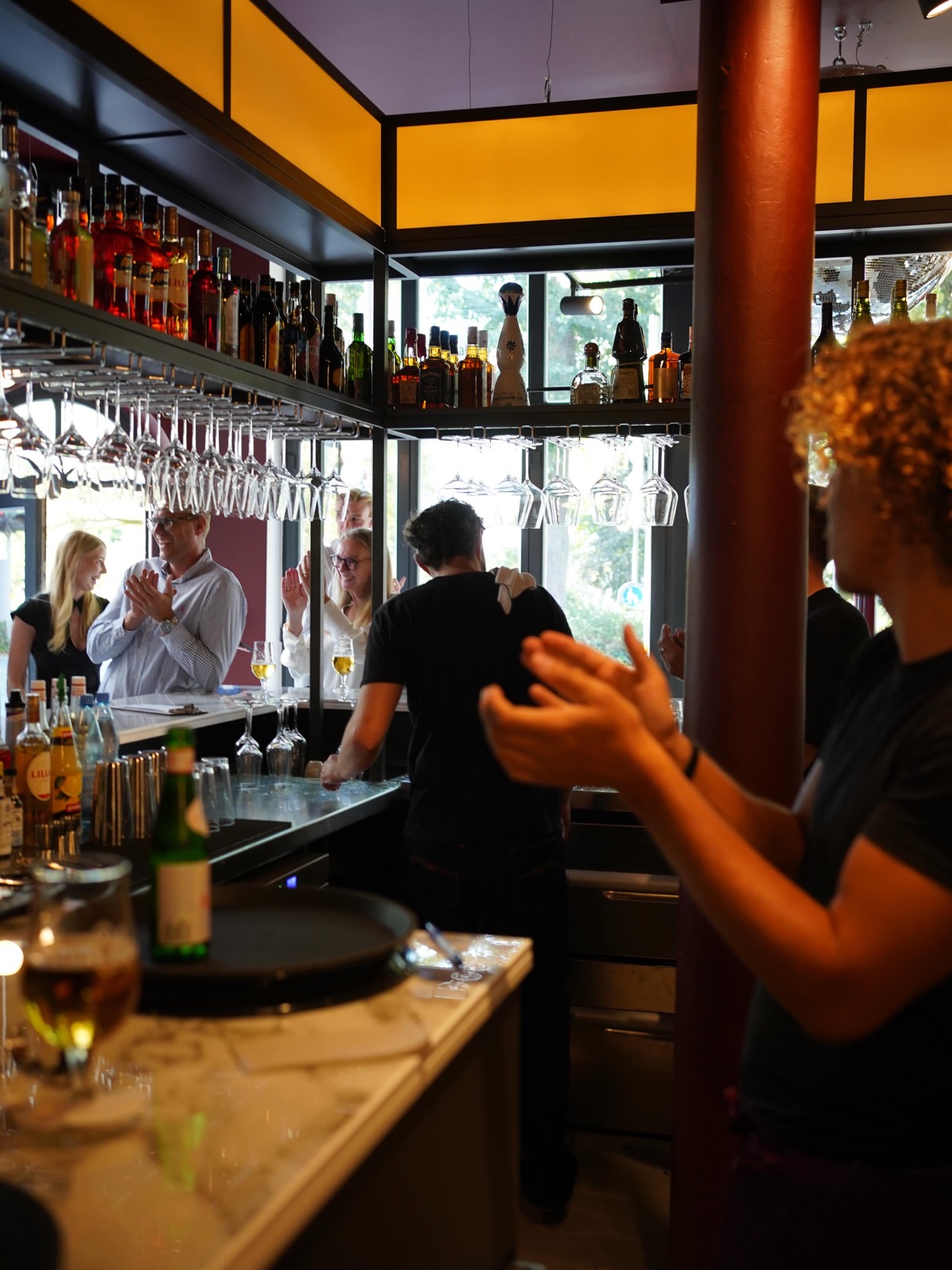 Team applaudiert an der Bar